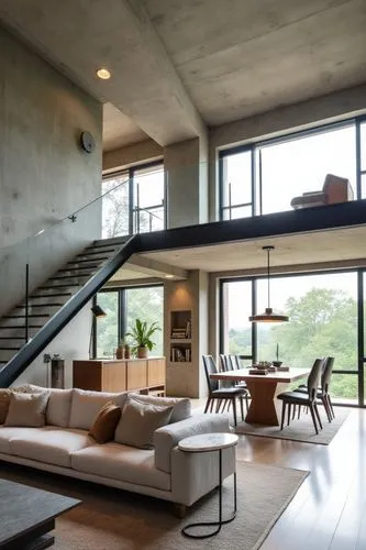 A modern loft with an open-plan design, featuring a double-height living space with floor-to-ceiling windows that flood the interior with natural light, the lower level includes a spacious living room