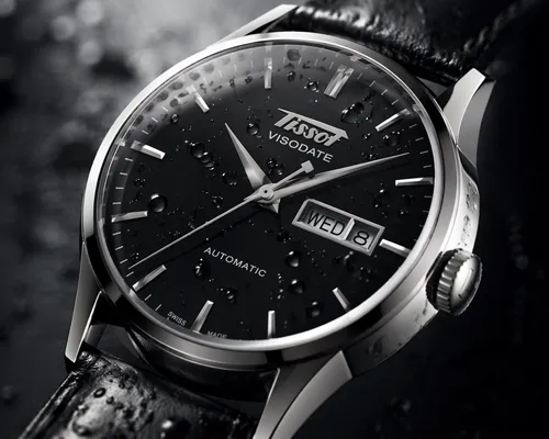 a product macro shot of a Tissot Heritage Visodate Automatic watch, black leather strap, black dial. with droplets on its face
,a close up view of a watch on a black and white surface,chronometer,chro