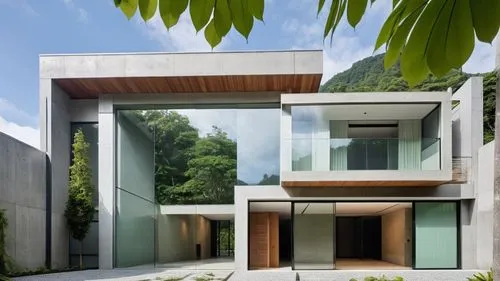 modern style building with glass facade next to trees,cubic house,modern house,cube house,modern architecture,glass facade,frame house,residential house,cantilevers,prefab,cantilevered,mirror house,fo