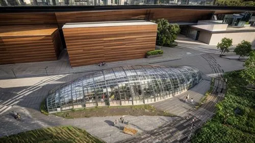 its a supermarket with a glasshouse on top
some plants in the upper part, the glasshouse
wooden planks in the lower with dark window frames
nein the window some supermarket shelfs
some passengers that