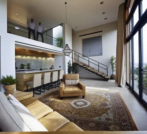 As the sun sets behind a spacious interior, a minimalist style loft, showcasing an eclectic mix of architecture and decor. The room is filled with the plush cushions and sleek surfaces that contrast b