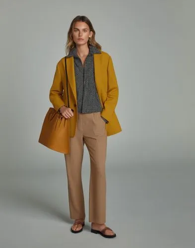 a model wearing a mustard colored coat and slacks,menswear for women,woman in menswear,maxmara,yellow brown,overcoats,krakoff,Photography,General,Realistic