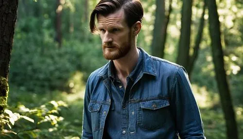 Matt Smith, bearded, masculine, strong facial features, short brown hair, thick beard, mustache, blue eyes, casual wear, denim shirt, jeans, sneakers, standing, relaxed posture, hands in pockets, natu