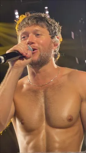 Naked man ,shirtless man singing into a microphone while singing on stage,chmerkovskiy,elkann,manganiello,papadoyiannakis,chaderton,jon