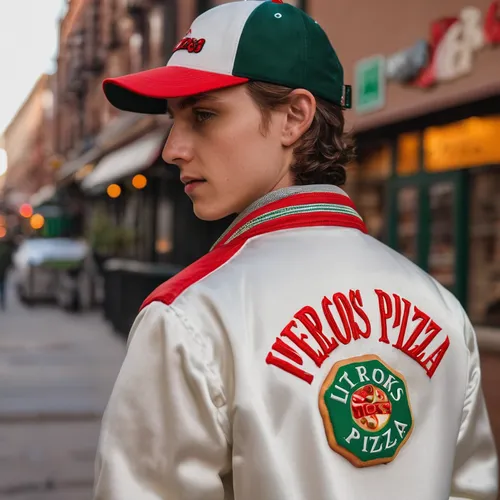 a 19 year old pizza delivery driver wearing a white satin jacket with white buttons, and a red white and green collar and cuffs and the Little Nero's Pizza patch from Home Alone on back of the jacket,