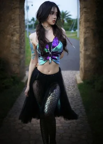 a woman is posing in a dark colored outfit,mermaid background,mermaid tail,mermaid,emeraude,believe in mermaids,dyesebel