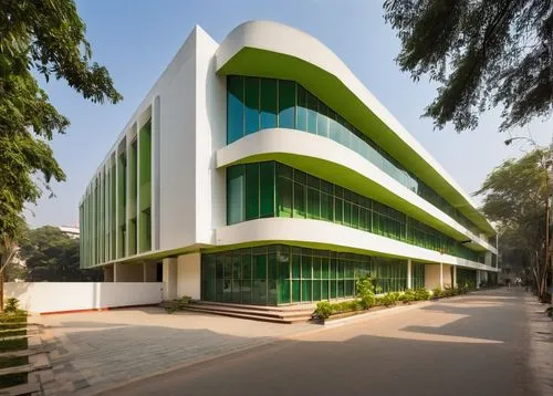 Delhi School of Architecture and Design, Kirti Nagar, modern building, angular structure, white walls, large windows, green glass facade, wooden doors, urban background, cityscape, trees lining the st