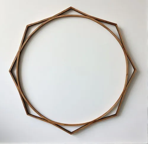 A frame made of wood against a white background,the circle has two intersecting lines on top of it,circle shape frame,copper frame,heart shape frame,wood mirror,oval frame,semi circle arch,Conceptual 