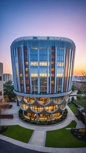 A magnificent building towering above the bustling streets of an urban neighborhood. This architectural marvel features sleek, modern lines and a facade adorned with expansive glass panels that reflec