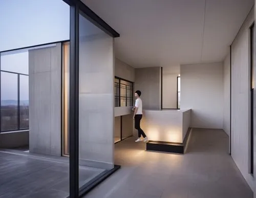 interior , lobby , concrete , black window frame,man at the counter standing in the entry hall with modern lighting,modern minimalist bathroom,luxury bathroom,penthouses,modern room,cubic house,sky ap