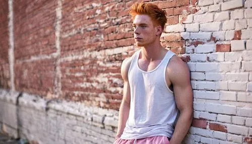 Muscular Shota, gay, ginger hair, messy styled, bright blue eyes, bold eyebrows, freckles on nose, pink blush, casual wear, white tank top, ripped denim shorts, sneakers, posing, leaning against a bri