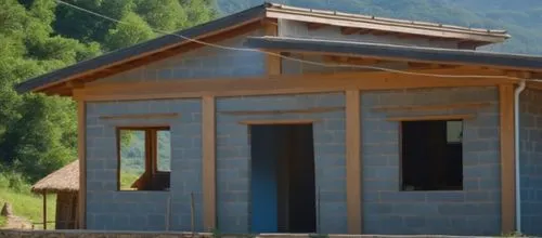 there is a small blue house with a thatch roof,passivhaus,outbuilding,traditional building,pokharel,traditional house,vivienda,timber house,wooden house,wooden hut,prefabricated buildings,a chicken co