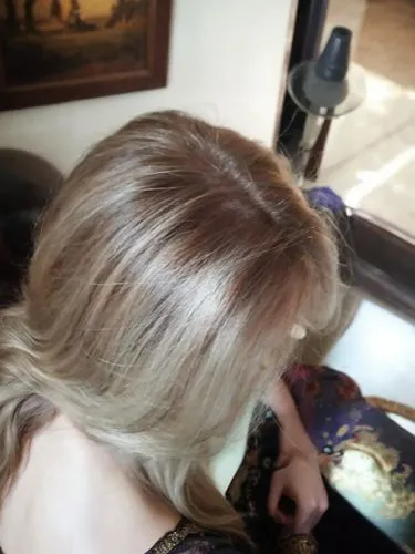 the woman is sitting sideways and has long hair,blonde,short blond hair,blond hair,blonde hair,back of head,chignon,long blonde hair,updo,blond,blonde woman,smooth hair,natural color,golden haired,blo