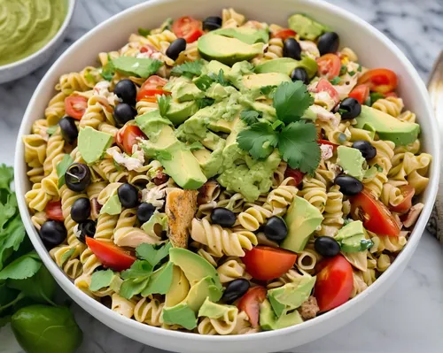 White bowl on marble counter filled with Mexican Chicken Southwest Pasta Salad with a Creamy Avocado dressing.,pasta salad,avocado salad,colorful pasta,mexican mix,noodle bowl,southwestern united stat