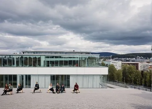 Oslo School of Architecture and Design, modern Scandinavian building, white facade, large glass windows, wooden accents, clean lines, minimalist aesthetic, urban landscape, AHO students, casual clothi