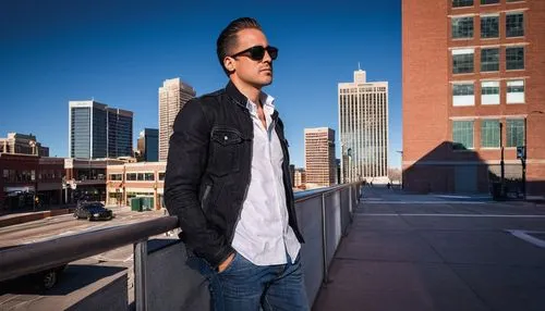 Male photographer, 30s, casual attire, denim jeans, white shirt, black jacket, sunglasses, Canon EOS camera, tripod, architectural photography, cityscape, Denver, Colorado, daytime, clear blue sky, mo