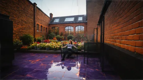 a beautiful garden with some fruit tress and a seating area with nice summer flowers in full blooms of different colours,courtyard,landscape design sydney,red bricks,landscape designers sydney,roof te