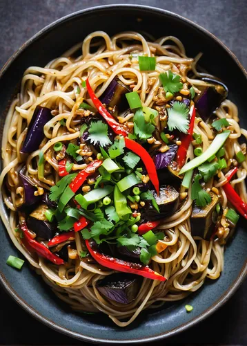 overhead shot of sichuan noodles with eggplant garnished with Thai chilies and green onions,chowmein,lo mein,jajangmyeon,singapore-style noodles,mongolian beef,stir-fry,moo shu pork,kung pao chicken,s