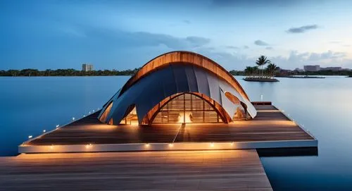 A pavilion with aspect comteporary but built with a cover of wood like the mangrove sticks, huge windows and a central plaza outdoor, peoples enjoy the enviroment in front the Chambacu lagoon in Carta