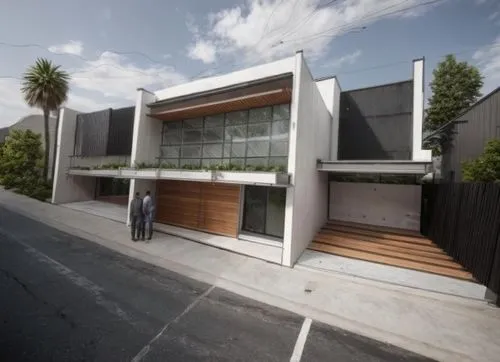 ASFALTO,two men stand next to a house on the side of the road,cubic house,modern house,cube house,dunes house,modern architecture,eichler,mid century house,carports,smart house,frame house,weatherboar