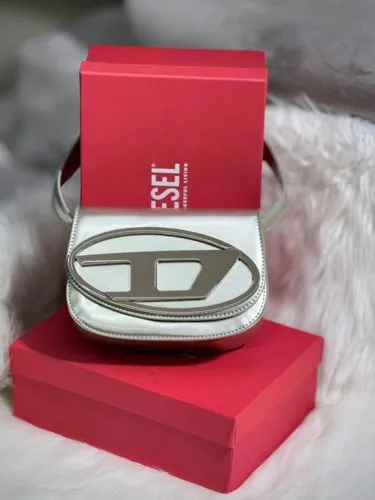 an id holder sits atop a red box,tlingit,fendi,red heart medallion,pytka,tsuba,bvlgari