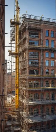 Industrial construction site, urban landscape, daytime, clear sky, bright sunlight, steel scaffolding pipes, yellow warning signs, safety nets, worn concrete floor, brick building facade, intricate st