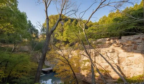 The frame is a stunning display of a large, rectangular block in the shape of a pillar, surrounded by vibrant stonework. The structure elongates upon a serene pond, its smooth surface glinting in the 