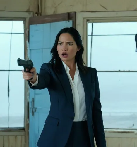 Olivia Munn in a suit
She is an abandoned Wearhouse

Olivia Munn is holding a pistol and pointing at a male criminal in a suit.
The criminal is infront of olivia. 

Show POV from behind


,the actress