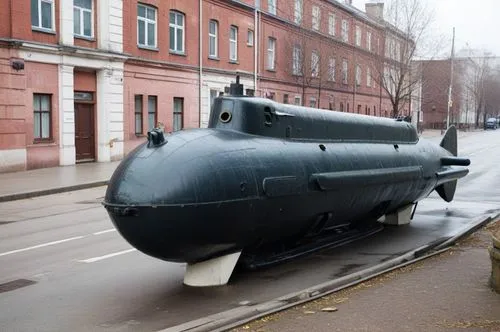 there is a large black object on a city street,ssgn,submarine,tank cars,ssbn,bathyscaphe,submarino