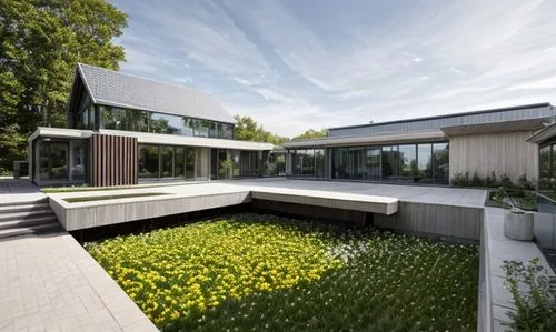 modern house with flower garden,modern house,danish house,residential house,house hevelius,modern architecture,frisian house,cubic house,dunes house,archidaily,residential,grass roof,glass facade,swis