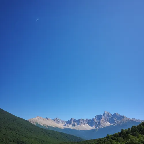 A serene mountain landscape with a clear blue sky,the chubu sangaku national park,bucegi mountains,japanese alps,tateyama,mountainous landscape,grand bleu de gascogne,clear sky,caucasus,japanese mount