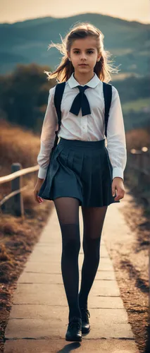 Graceful schoolgirl walking on the horizon, wearing tights, evening. High-angle shot. Duotone color grading.,little girl running,girl walking away,little girls walking,school skirt,girl in a long,run,