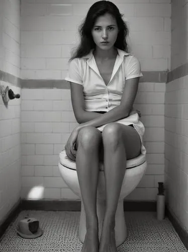 Sitting woman,a young woman sitting on a toilet in a bathroom,premenstrual,menstruate,menstruation,scodelario,depressed woman,menstruating,Photography,Black and white photography,Black and White Photo