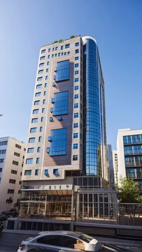 a very tall building with many windows near a parking lot,rotana,largest hotel in dubai,mubadala,abdali,sandton,difc,masdar,habtoor,ajman,manama,afreximbank,salmiya,shuwaikh,khalidiya,addis ababa,daeg