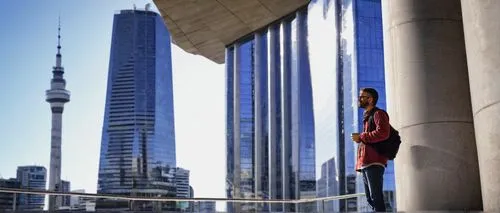 Modern architecture, part-time job, Auckland city, 30yo male, casual attire, laptop bag, coffee cup, standing, leaning on a concrete pillar, urban background, glass skyscraper, steel beams, minimalist