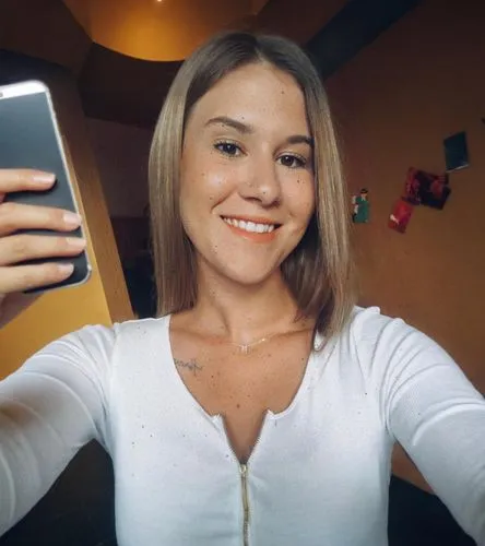 blonde,iphone x,phone icon,short blond hair,smiling,instagram icon,htc,blonde girl with christmas gift,camera,holding ipad,tan,taking picture with ipad,white shirt,mobile camera,new,smiley,blonde girl