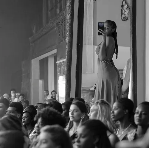 Beautyfull young african woman. Black and white. Many spectators in a Fashion public show,havana,concert crowd,audience,crowd,crowds,concert,girl in a long dress from the back,onlookers,partition,a gi