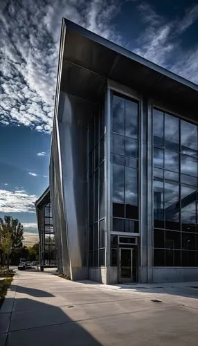 David Architectural Metals Inc., modern industrial building, silver metallic exterior, sleek lines, angular structure, large glass windows, steel beams, corrugated roof, urban cityscape background, co