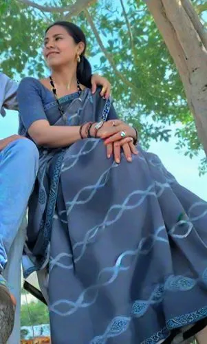 a man sitting next to a woman on top of a tree,chipko,bhanwari,gautami,sarasaviya,kadhal,jayaprada