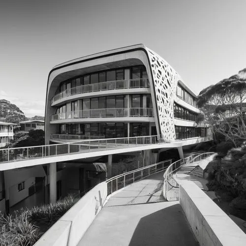 Wollongong university building, modern architecture, curved lines, glass facade, white concrete walls, sloping roof, greenery balcony, steel beams, wooden floors, minimalist interior, natural lighting