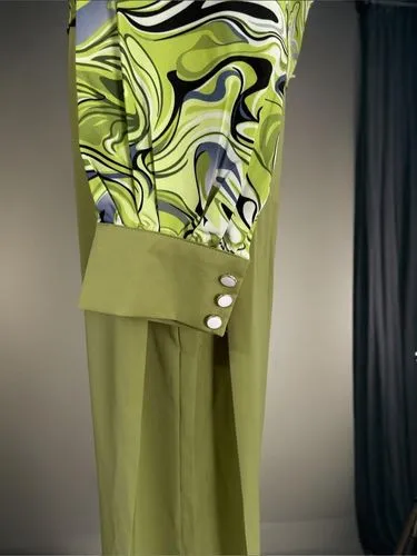 a green dress with ons at the bottom and a large pattern on it,vionnet,siriano,a floor-length dress,schiaparelli,moschini,fabric design