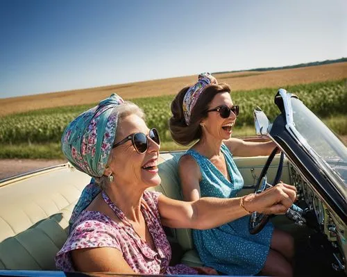 A whimsical comical middle aged woman in summer dress head scarf on her hair driving a vintage '60's open top car. Sunglasses on both of them. Her hand on the stirring wheel laughing enjoying an adven