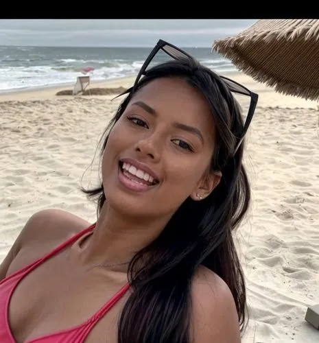 She is sunbathing on the beach.  wearing a colorful swimsuit.  She is lying on the beach and laughing.,marshallese,filipina,thahane,cambodiana,mexicana,irigoyen,filipino,amerie,kaikini,cambodian,panam