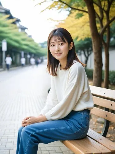 young japanese woman sits on a bench,a woman sitting on top of a wooden bench next to trees,kaori,riho,eriko,mayuko,mikiko,hiromi