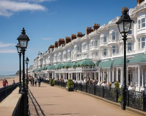 Regency-style, Victorian-era inspired, Leighton on Sea promenade, grandiose ironwork balconies, ornate facades, white stucco walls, large sash windows, carved wooden doorways, intricate stonework, sea