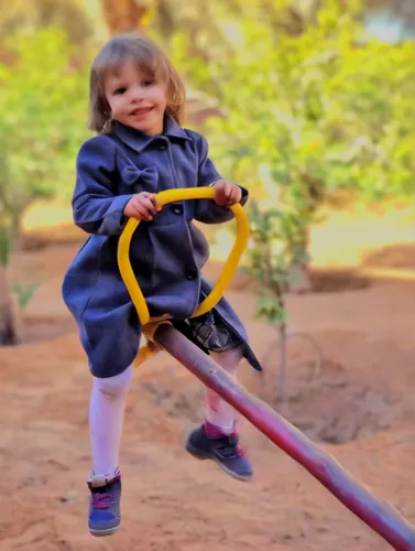 outdoor play equipment,child in park,children jump rope,little girl with umbrella,playing outdoors,swing set,little girl twirling,little girl running,child playing,garden swing,child care worker,wooden swing,diabetes in infant,swinging,little girl in wind,photographing children,photos of children,little girls walking,playground slide,golden swing