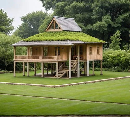 a large green roof in front of trees and green grass,grass roof,greenhut,ecovillages,robotic lawnmower,miniature house,stilt house,Photography,General,Realistic