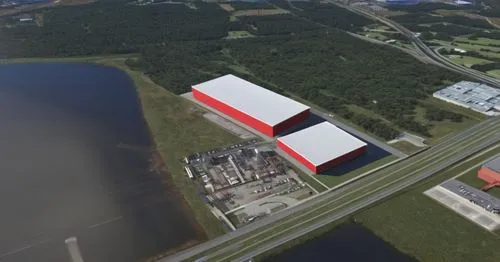 This is a sketch for an industrial retail center 
In the center of the image, the two boxes with white roofs and red facade is the retail center,
The grey is the limit of the site with parking in fron