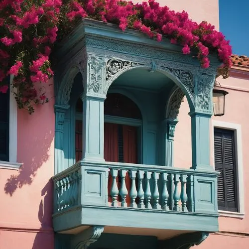 St Augustine Florida, Spanish colonial architecture, pastel-colored buildings, ornate stone carvings, wrought iron balconies, red-tiled roofs, narrow cobblestone streets, flowering bougainvillea, palm