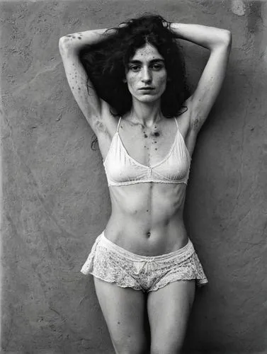 Black and white portrait of a pale, lower-class gypsy woman with blemished and blotchy skin who is in a trance. She has never shaved her dark underarm hair, which is very noticeable. The overall impre